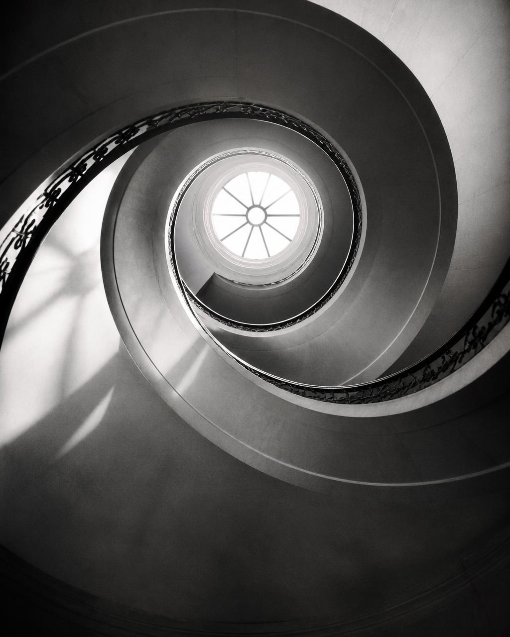 Abstract photograph of a spiral staircase from below