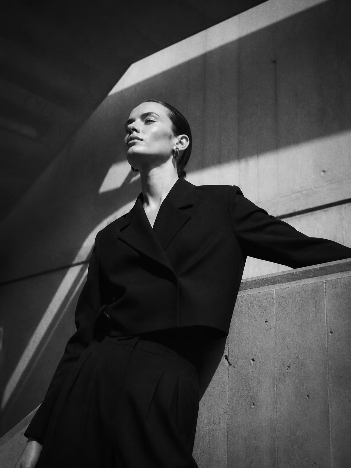 High fashion editorial photograph in a concrete architectural space
